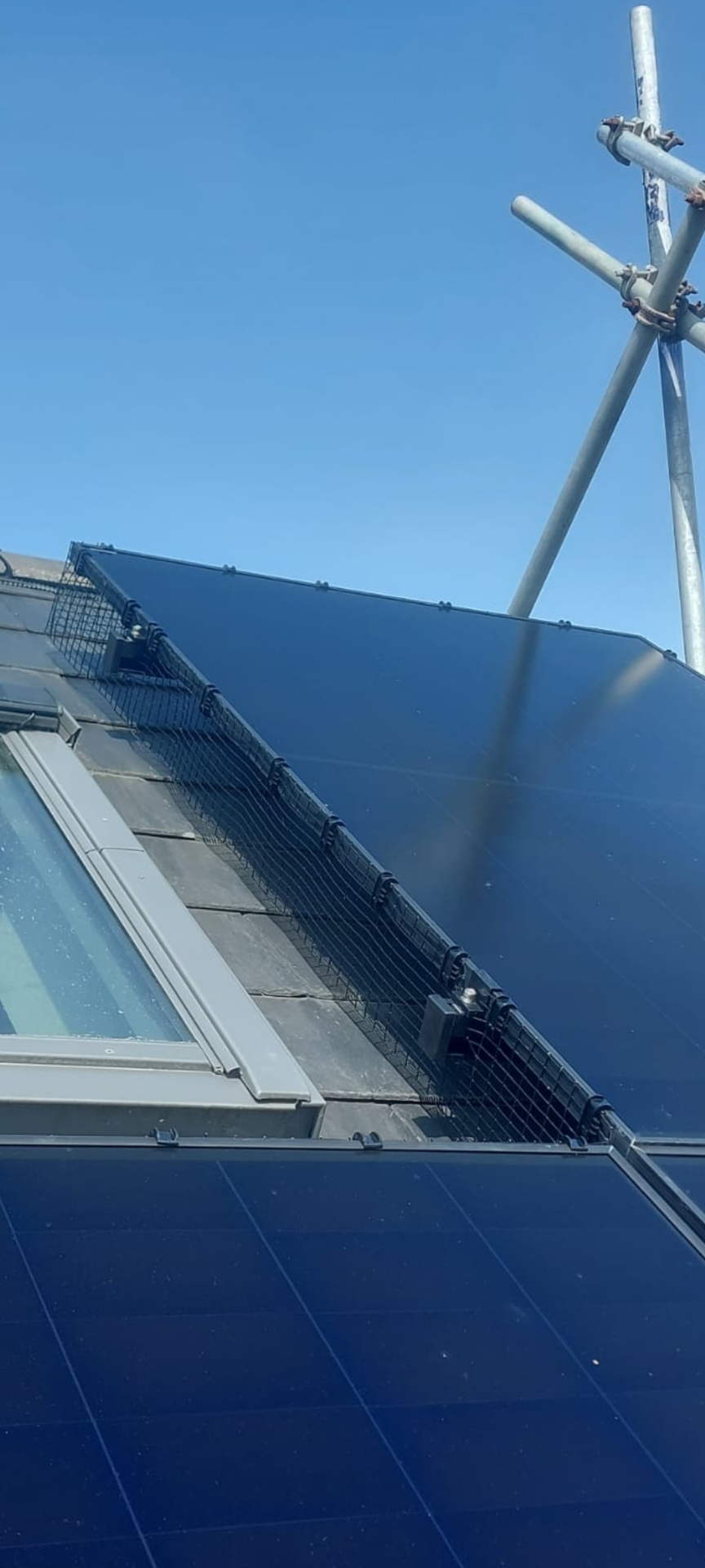 Bird proofing mesh installed around rooftop solar panels by Engage Solar in Devon