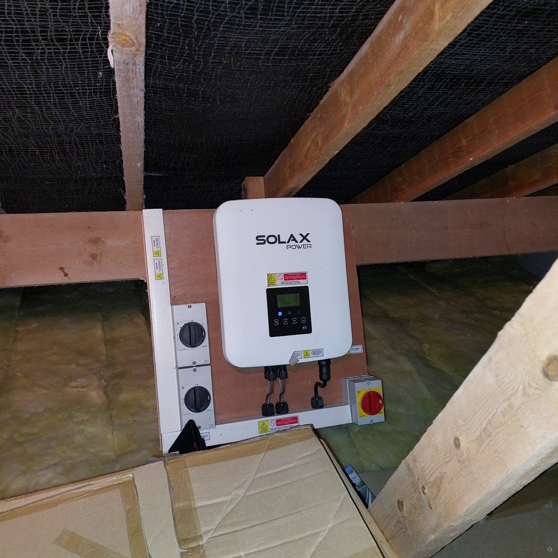 Solar inverter inspection carried out in a Devon loft space during a property survey by Engage Solar